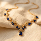 Gold-Tone Leaf Vine Necklace with Blue Stones and Pear Drop
