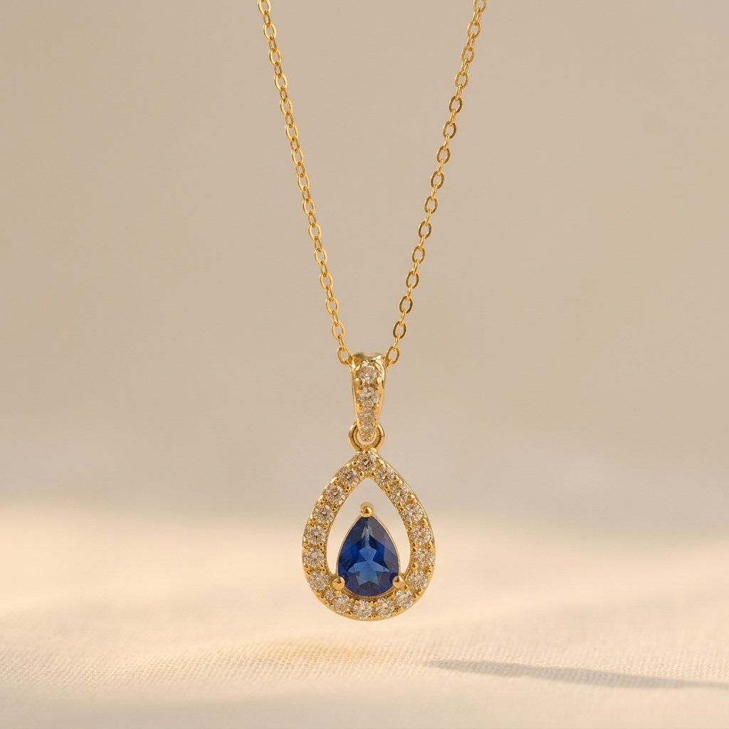 Gold-Tone Open Pear Halo Pendant with Blue Stone