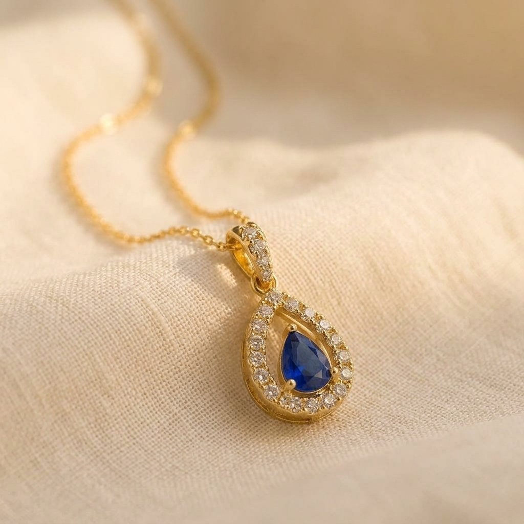 Gold-Tone Open Pear Halo Pendant with Blue Stone
