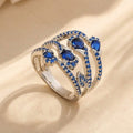 Silver-Tone Wide Crossover Ring with Blue Pavé and Pear Stones