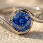 Silver-Tone Swirl Bypass Ring with Round Blue Stone